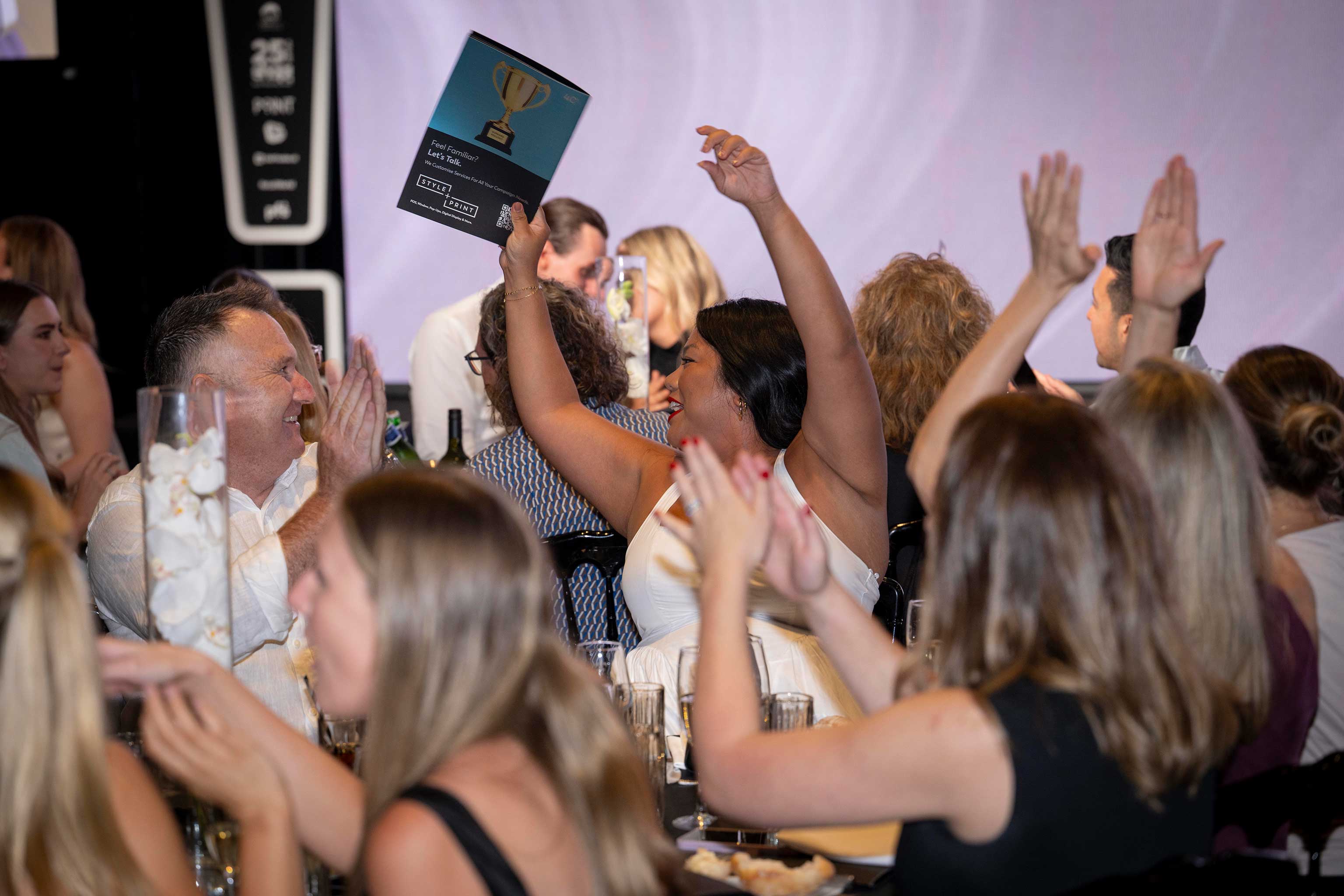 woman cheering at awards ceremony